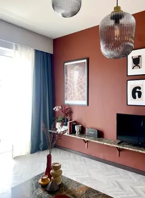 a living room with red walls and a table at TESSERA Urban Chania in Chania Town