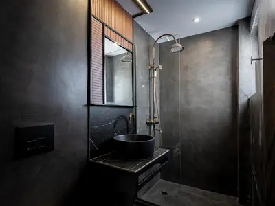 a black bathroom with a sink and a shower at TESSERA Urban Chania in Chania Town