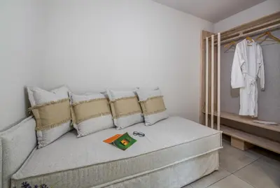 a living room with a couch with pillows at Eleana Nature & Art in Khóra Sfakíon
