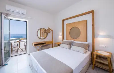 a bedroom with a bed and a view of the ocean at Eleana Nature & Art in Khóra Sfakíon