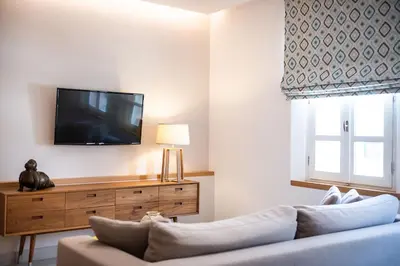 a living room with a couch and a flat screen tv at Avra Apartments Venetian Harbour in Chania Town