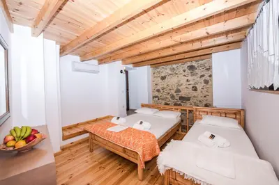 a room with two beds and a table at Fairytale Elafonisi in Elafonisi