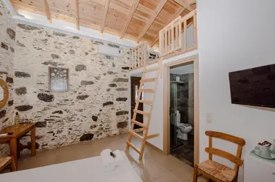 a staircase in a room with a stone wall at Fairytale Elafonisi in Elafonisi