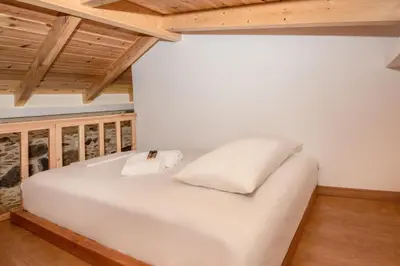 a white bed in a room with wooden ceilings at Fairytale Elafonisi in Elafonisi