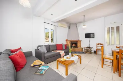 a living room with a couch and a table at Villa Dimitris in Vlikhádha