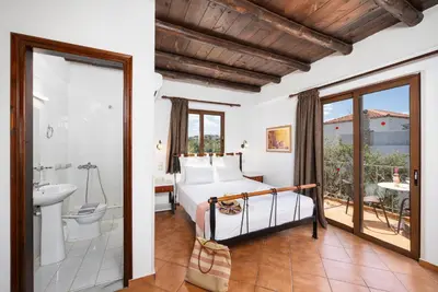 a bedroom with a bed and a bathroom at Villa Tzina in Plataniás