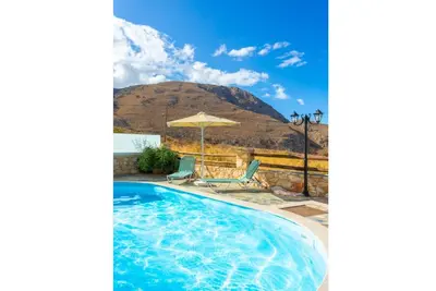 a swimming pool with a mountain in the background at Villa Konstantina in Exopoli