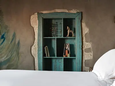 a bedroom with a blue cabinet with a dog on it at Domus Fresco in Chania Town