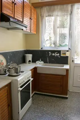 a small kitchen with a stove and a sink at Alexandra Apartment Near Chania Center in Chania Town