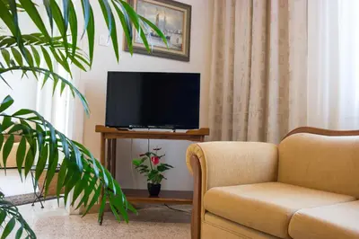 a living room with a couch and a television at Alexandra Apartment Near Chania Center in Chania Town