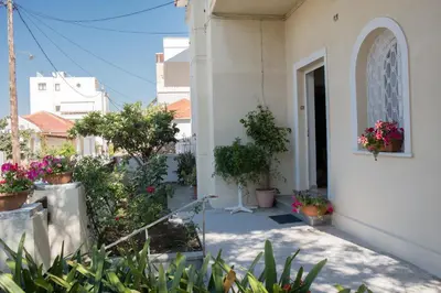 a house with potted plants on the side of it at Alexandra Apartment Near Chania Center in Chania Town