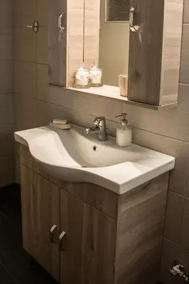 a bathroom with a white sink and a mirror at Alexandra Apartment Near Chania Center in Chania Town