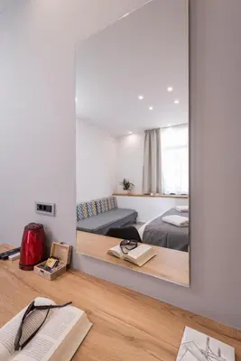 a mirror in a room with a bed and a bedroom at Central City Hotel in Chania Town