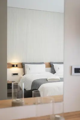 a bedroom with two beds and a glass table at Central City Hotel in Chania Town