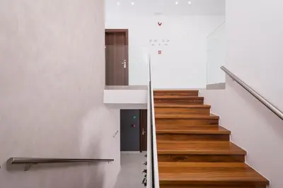 a staircase in a house with white walls and wooden floors at Central City Hotel in Chania Town