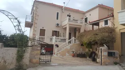 a white house with a staircase in front of it at Estrella Studios in Chania Town