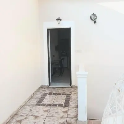 a white room with a door and a table at Estrella Studios in Chania Town