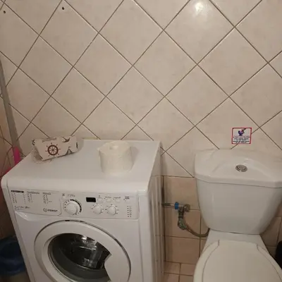 a bathroom with a toilet and a washing machine at Estrella Studios in Chania Town