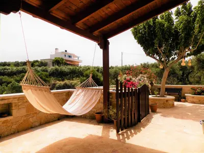 a patio with two hammocks hanging from a pergola at Villa Athina in Kissamos