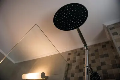a shower head in a bathroom with a ceiling at Niovi Seaside Suites in Kissamos