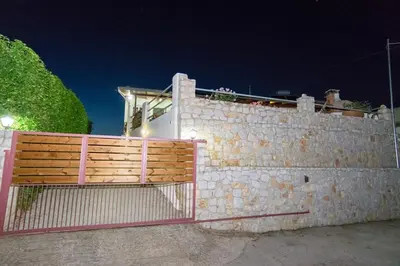 a brick wall with a gate on top of it at Ortaki Traditional House in Loúlos