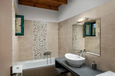 a bathroom with a sink and a bath tub and a sink at Villa Piedra in Manoliópoulon