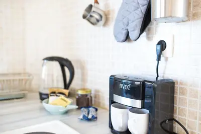 a coffee maker on a counter in a kitchen at Yasmine Apartments and Rooms in Kato Daratso