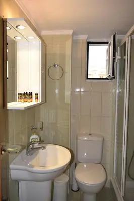 a bathroom with a white toilet and a sink at Astrantia in Chania Town
