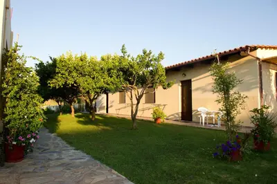 a garden with trees and a house with a lawn at Studios Kydonia in Gerani Chanion