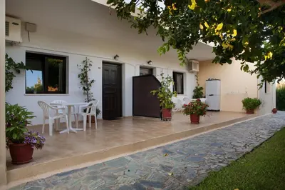 a patio of a house with a table and chairs at Studios Kydonia in Gerani Chanion