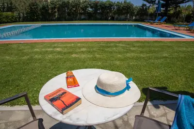 a white table with a hat and a cake on it at Studios Kydonia in Gerani Chanion