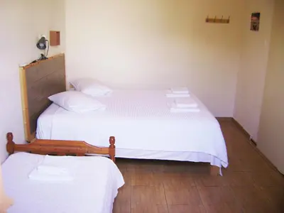 a bedroom with two beds with white sheets at White Lake Holiday House in Elafonisi