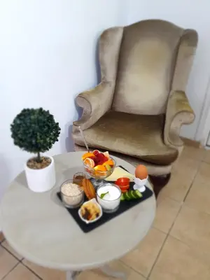 a tray of food on a table next to a chair at Elizabeth Suites in Kato Daratso