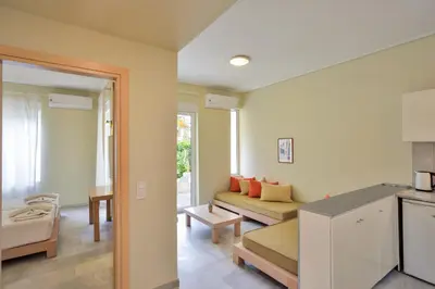 a kitchen and living room with a couch and a table at Elma's Dream Apartments & Villas in Kato Daratso