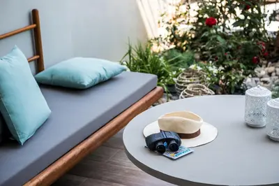 a bed with a table with a hat and a table at No17 Pireos Street in Chania Town
