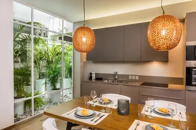 a kitchen with a dining table and two lights at No17 Pireos Street in Chania Town