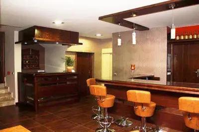 a kitchen with a bar with brown stools at Hotel Filoxenia in Chania Town