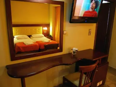 a bedroom with a bed and a large mirror at Hotel Filoxenia in Chania Town