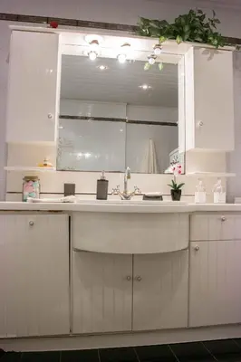 a kitchen with a sink and a mirror at Alexandra Villa Stalos in Stalos