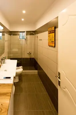 a bathroom with a shower and a toilet and a sink at Eleni Apartments in Chania Town