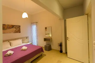 a bedroom with a bed with two towels on it at Eleni Apartments in Chania Town