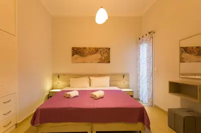 a bedroom with a bed with two towels on it at Eleni Apartments in Chania Town
