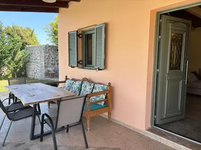 a patio with a couch and a table and chairs at Villa Adriana in Arménoi