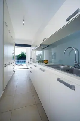 a kitchen with white cabinets and a sink at Seametry Villa in Chania Town