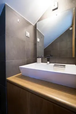 a bathroom with a large tub and a mirror at Seametry Villa in Chania Town