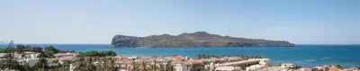 a view of a city and an island in the water at Ekavi Apartments in Agia Marina Nea Kydonias