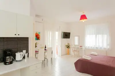 a kitchen and a living room with a bed and a table at Halepa Studios in Chania Town