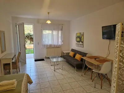 a living room with a couch and a table at Halepa Studios in Chania Town