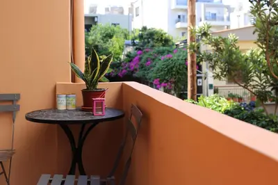a small table on a balcony with a plant at Halepa Studios in Chania Town