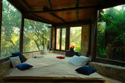 a large bed in a room with large windows at Elia Hotel & Spa in Áno Voúvai